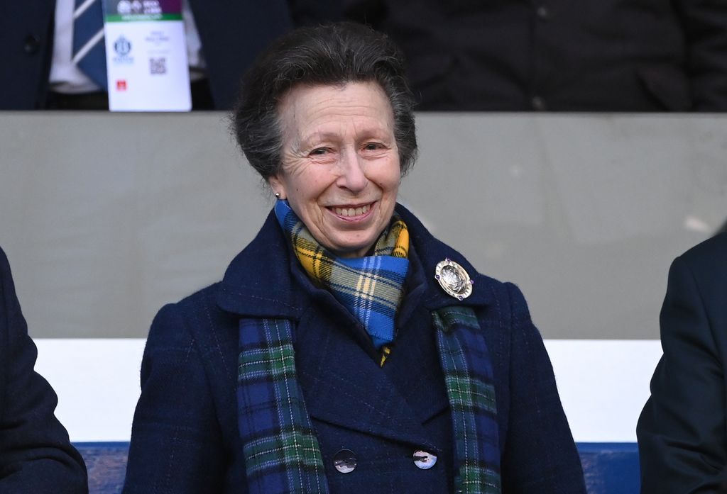 Princess Anne wearing a tartan scarf at the rugby