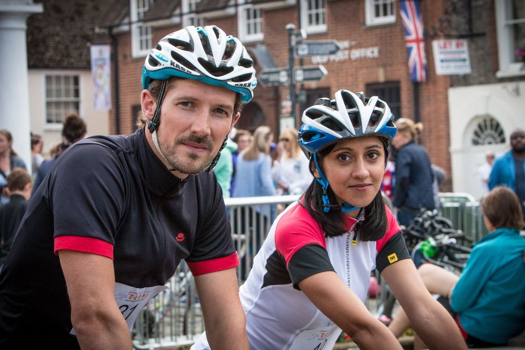 man and woman wearing bike helmets and lyra
