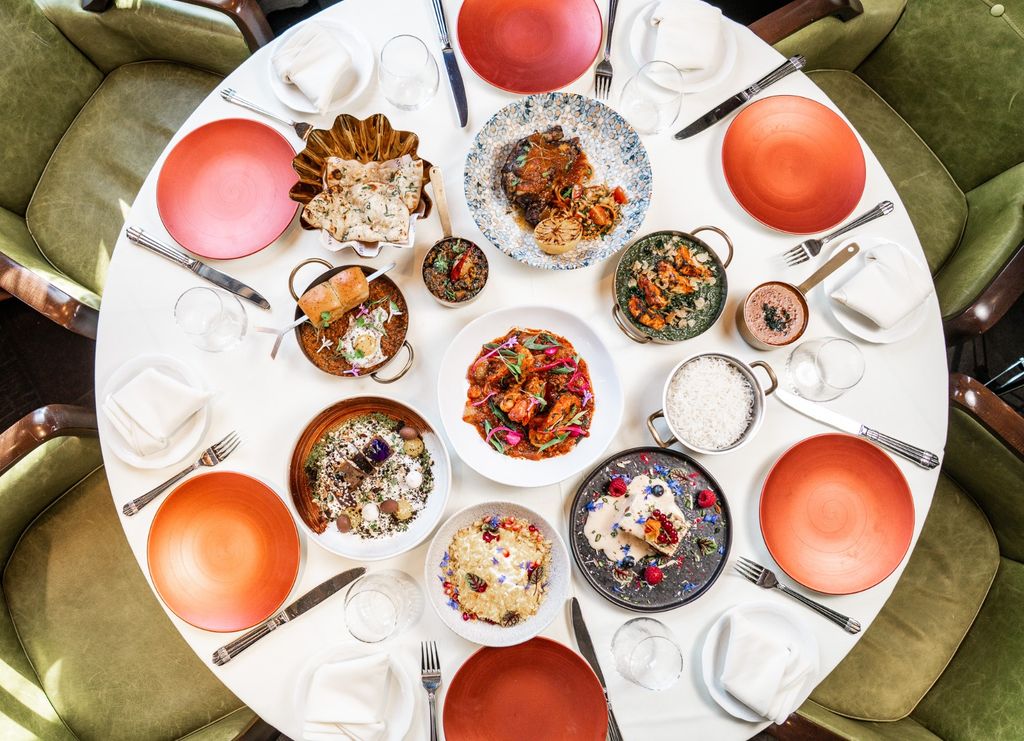 aerial view of food on table with olive green chairs