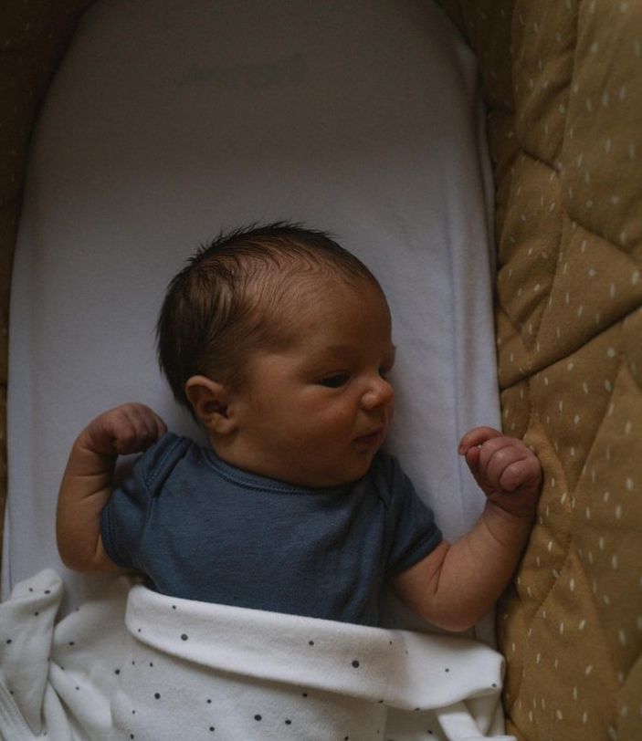 A baby in a cot