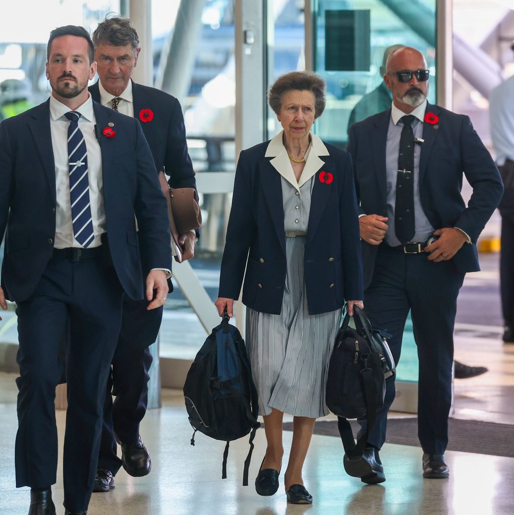 Princess Anne in airport with husband and two other men