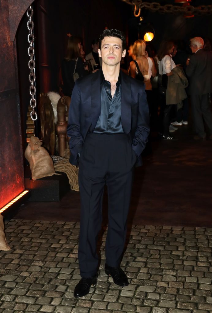 A photo of a man in a black suit 