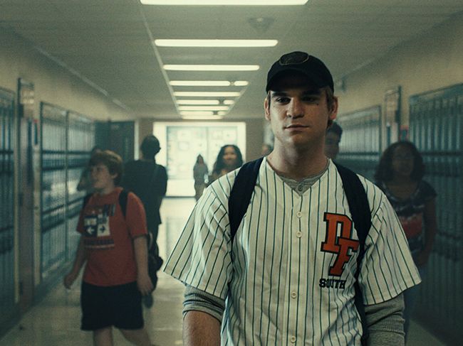Actor playing Nicholas Barclay walks through High School
