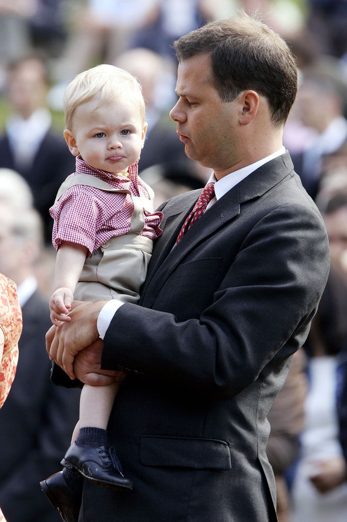 Prince Constantin carrying a baby boy