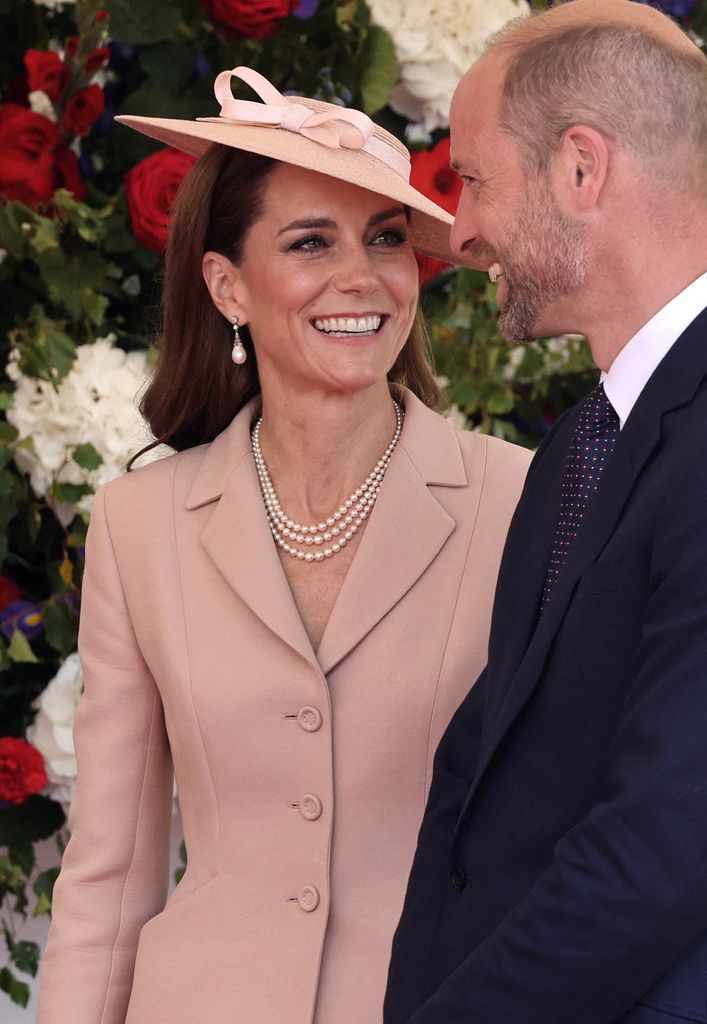 Kate and William smiling at each other 