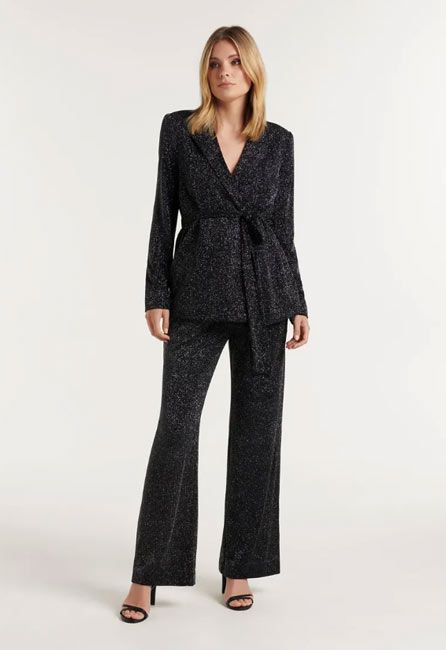 model wearing a the harlow black glittery trouser suit
