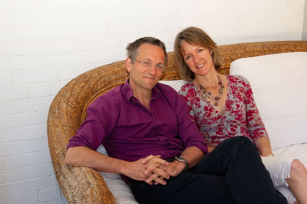Micheal Mosley and his wife sitting on a wicker chair