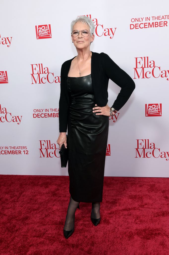 Jamie Lee Curtis on red carpet hand on hip in black leather midi dress