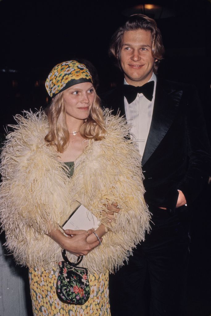 Jeff Bridges, wearing a tuxedo and bow tie, and his partner, Susan Geston, who wears a pale yellow ostrich feather jacket over a floral pattern dress with a matching headscarf, attend the 47th Academy Awards, at the Dorothy Chandler Pavilion in Los Angeles, California, 8th April 1975