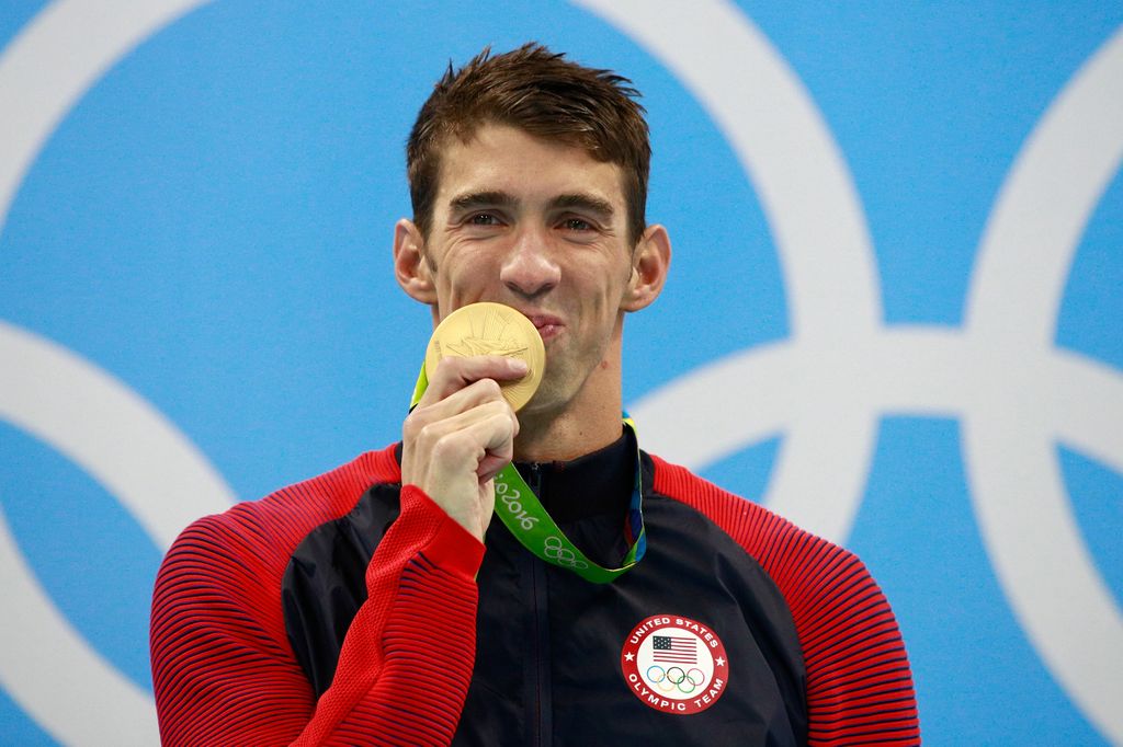 Gold medalist Michael Phelps of the United States celebrates on the podium during the medal ceremony for the Men's 200m Individual Medley Final on Day 6 of the Rio 2016 Olympic Games 