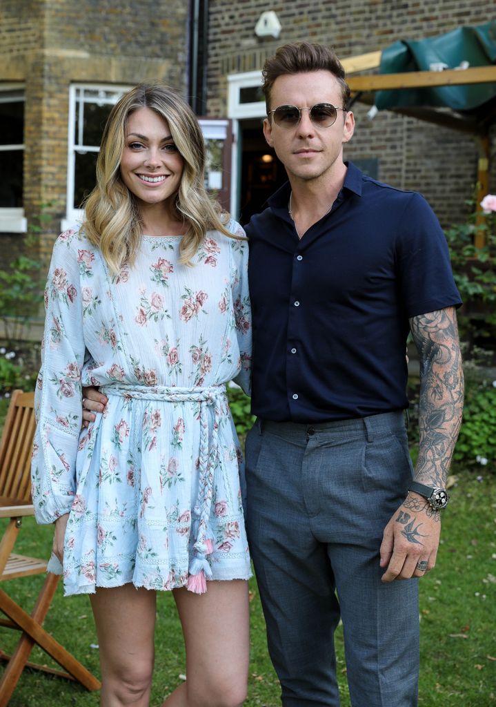 Danny and Georgia Jones smiling for camera at garden party