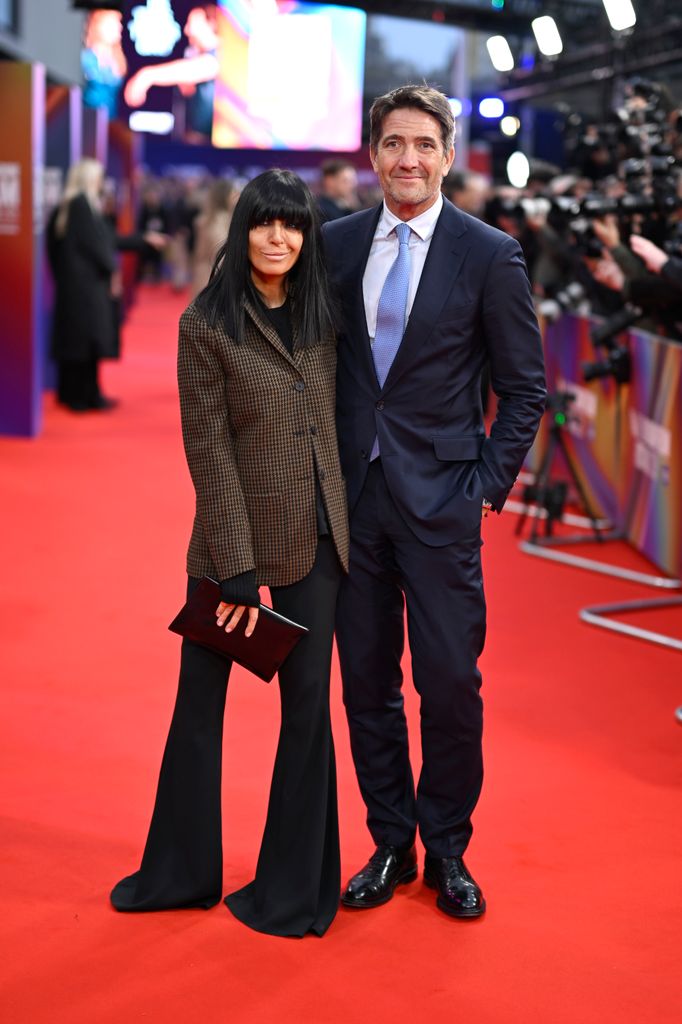 Claudia Winkleman standing with husband Kris Thykier