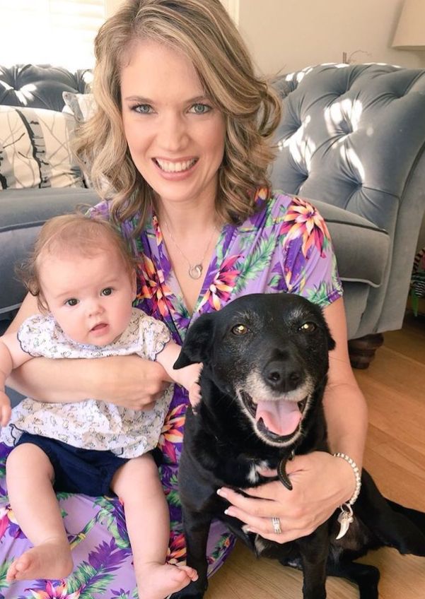 Charlotte Hawkins with baby girl and black dog
