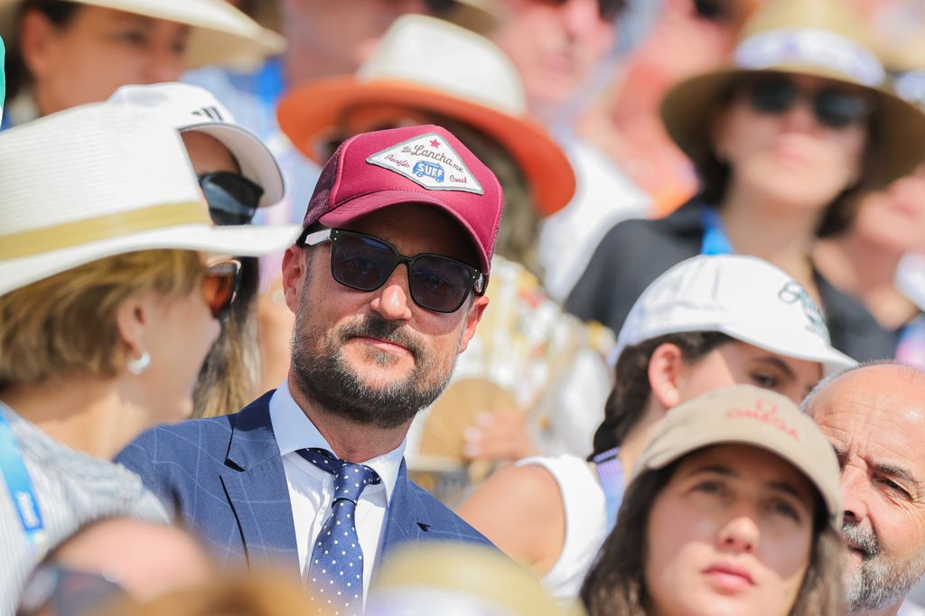 Crown Prince Haakon of Norway sits in the stands of the Olympic Games 