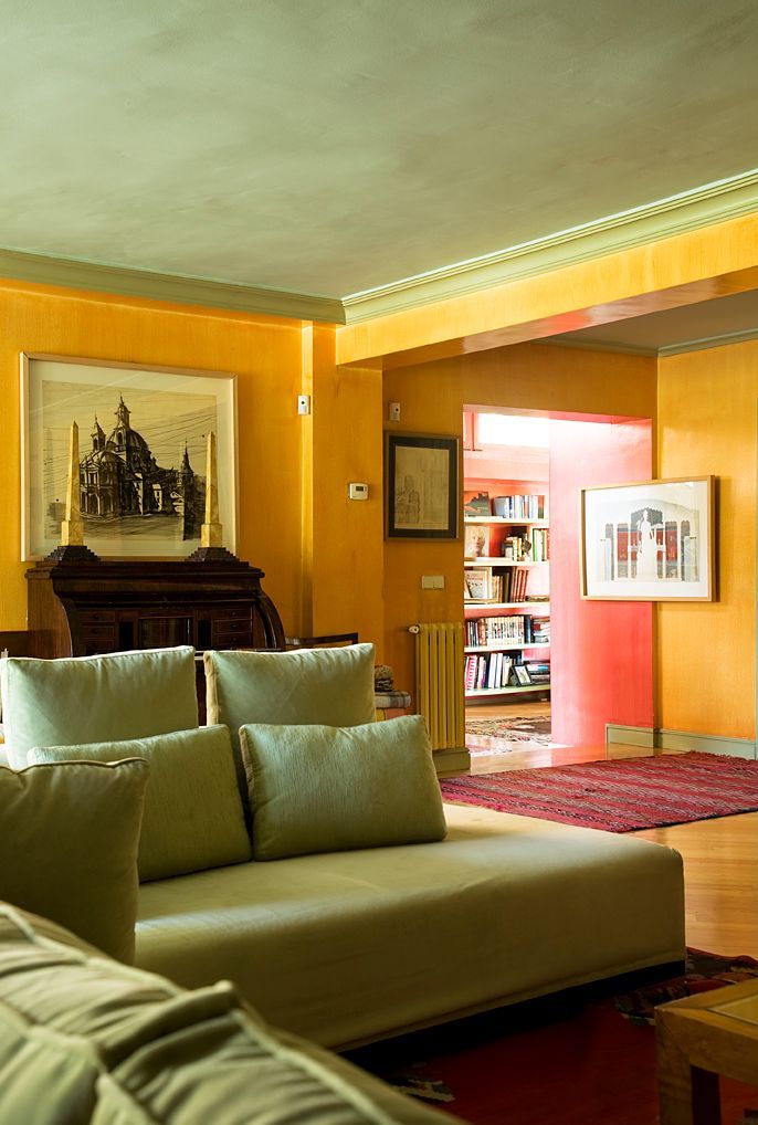 A warm, textured room with golden yellow walls and a pale sage green ceiling