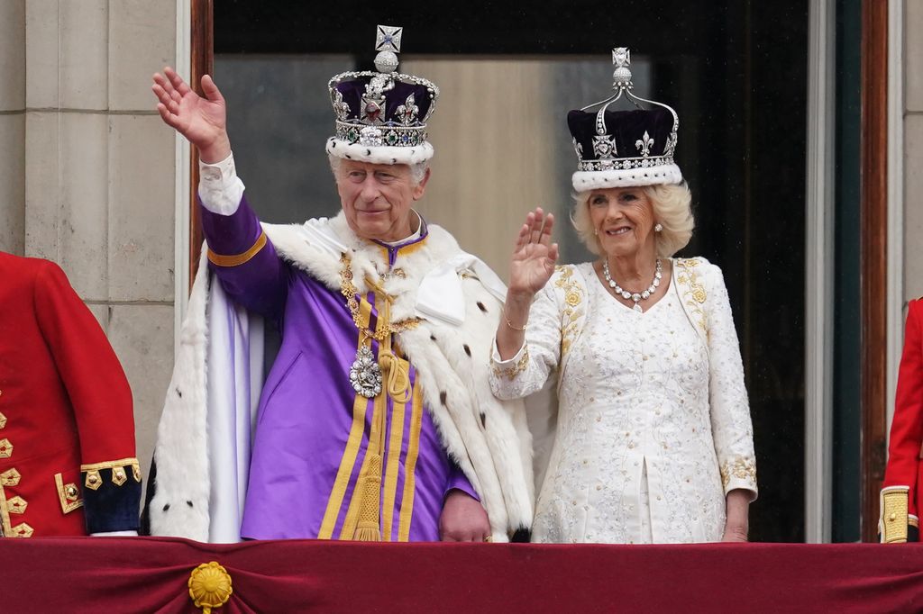 King Charles III and Queen Camilla on the balcony of Buckingham Palace waving to the crowds