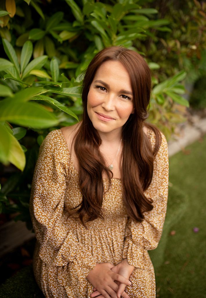 headshot of parenting expert and author Sophie David sitting in front of plants