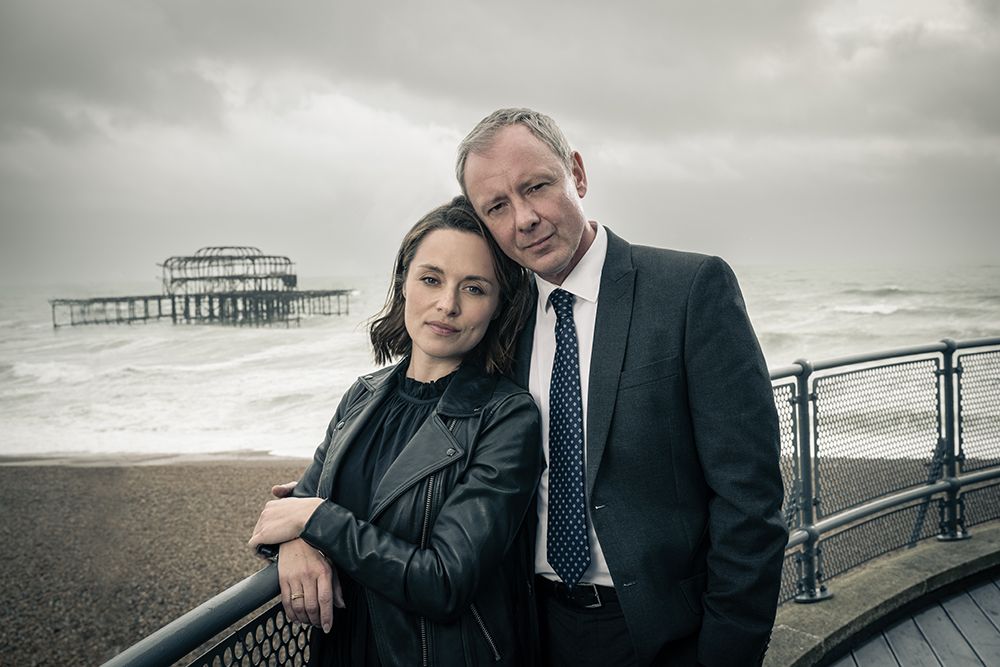 Zoe Tapper and John Simm pose on Brighton beach