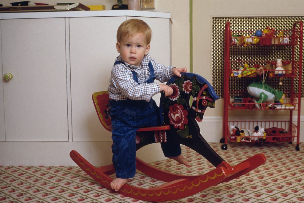 Prince Harry on a rocking horse in the playroom at Kensington Palace, 