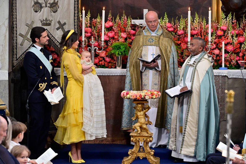 Prince Carl Philip of Sweden (L) and Princess Sofia of Sweden (2nd L) with Princess Ines and the christening celebrants the Chief Chaplain, Bishop Johan Dalman and the Pastor of the Royal Court Assembly, Ordinary Chaplain Michael Bjerkhagen