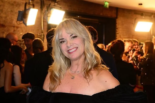 Tamzin Outhwaite smiling in a black off-the-shoulder dress