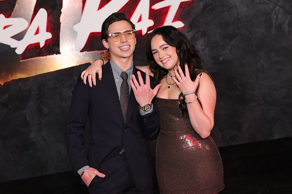 Mary Mouser and Tanner Buchanan posing with their engagement rings