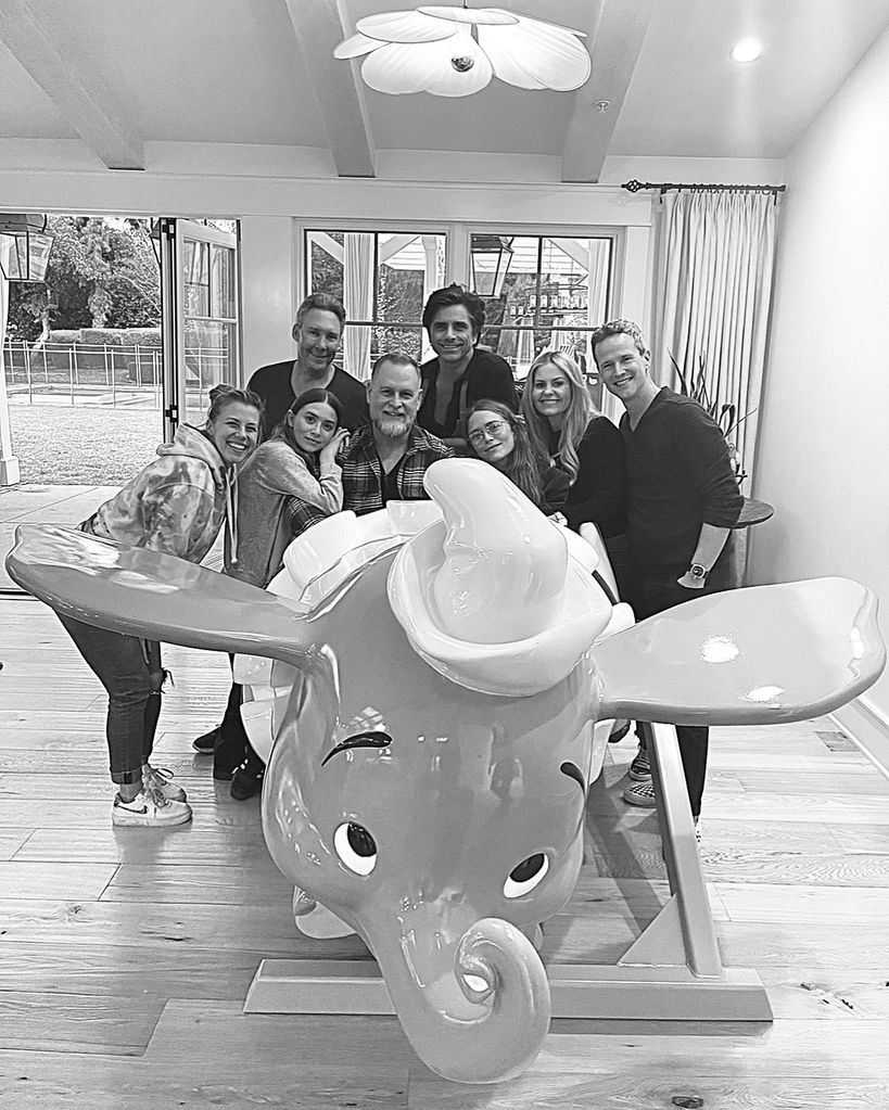 John Stamos with Full House cast members, including Mary-Kate and Ashley Olsen