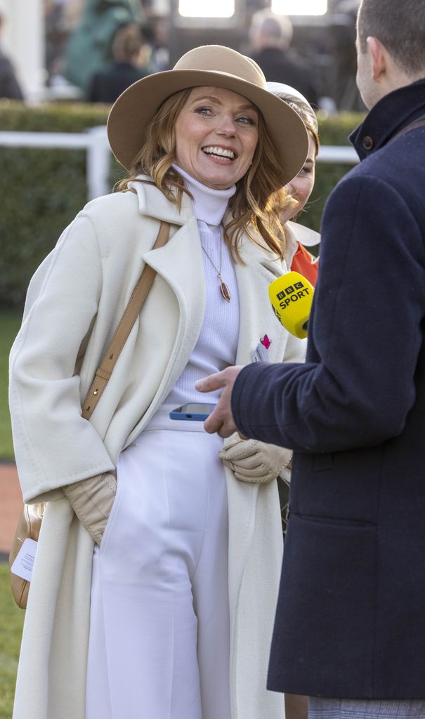 Geri Halliwell-Horner in a white outfit speaking to a reporter