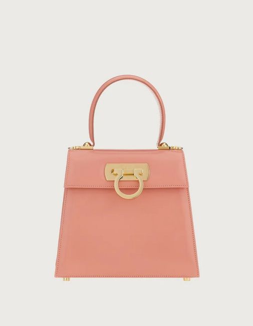 who designed jennifer lopez pink top handle bag with gold circle