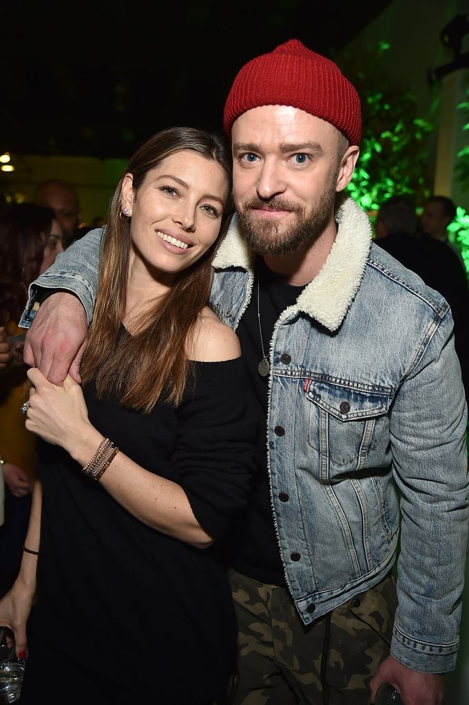 Jessica Biel and Justin Timberlake hug he wears a beanie