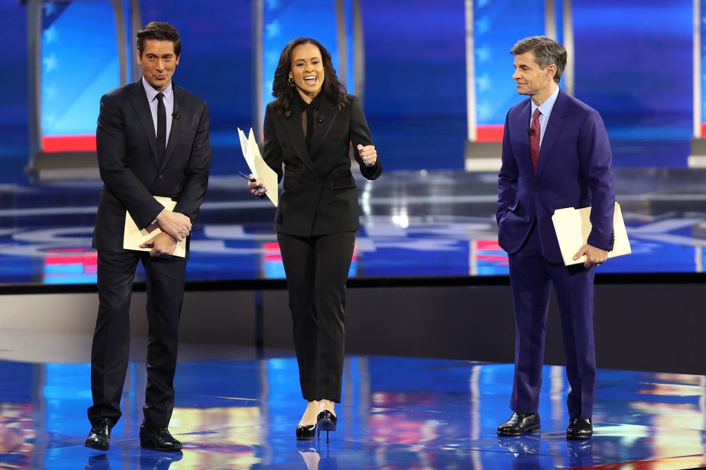 ABC network anchors and debate moderators David Muir, Linsey Davis and George Stephanopoulos speak on stage prior to the Democratic presidential primary debate in the Sullivan Arena at St. Anselm College on February 07, 2020 in Manchester, New Hampshire