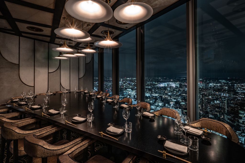 dining table, 60 floors up in the sky with views of londons skyline at night