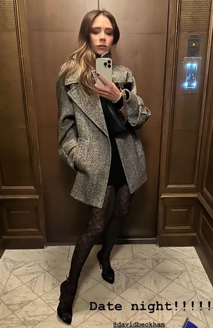 victoria takes a selfie in a mirror while wearing black netted tights