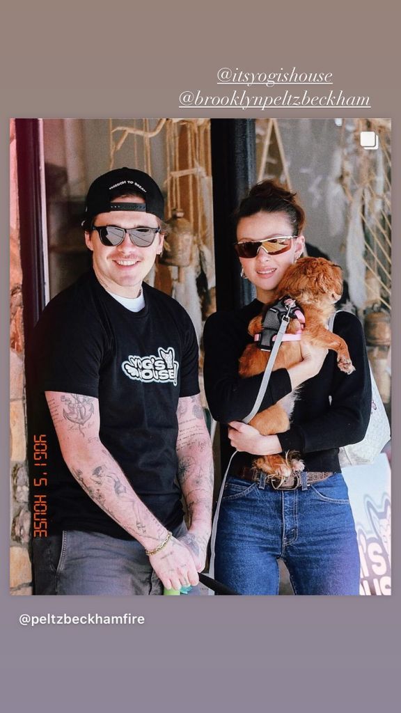 Brooklyn Beckham and Nicola Peltz holding a dog wearing a black jumper