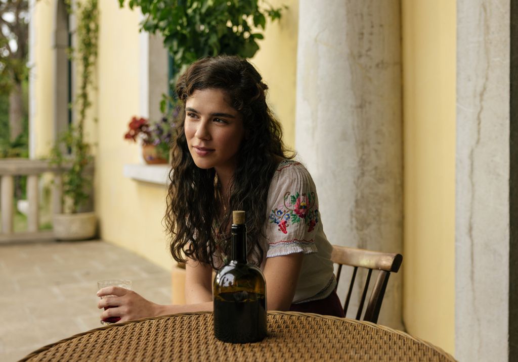 A woman sits at a table