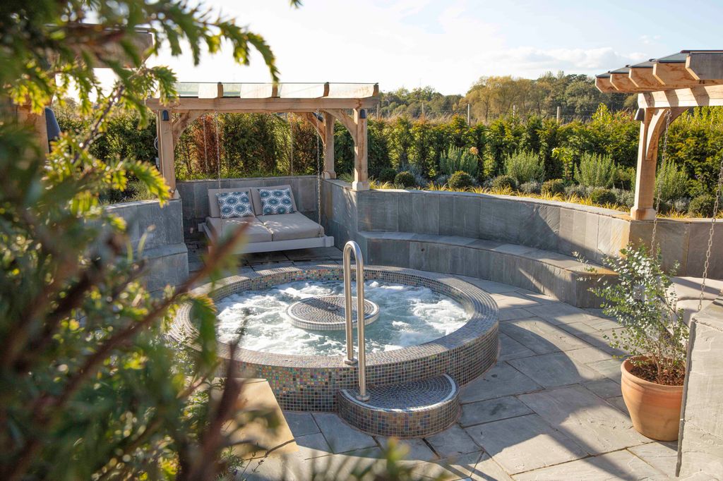 The outdoor hot tub in the sunshine at Manor House Hotel, Alsager