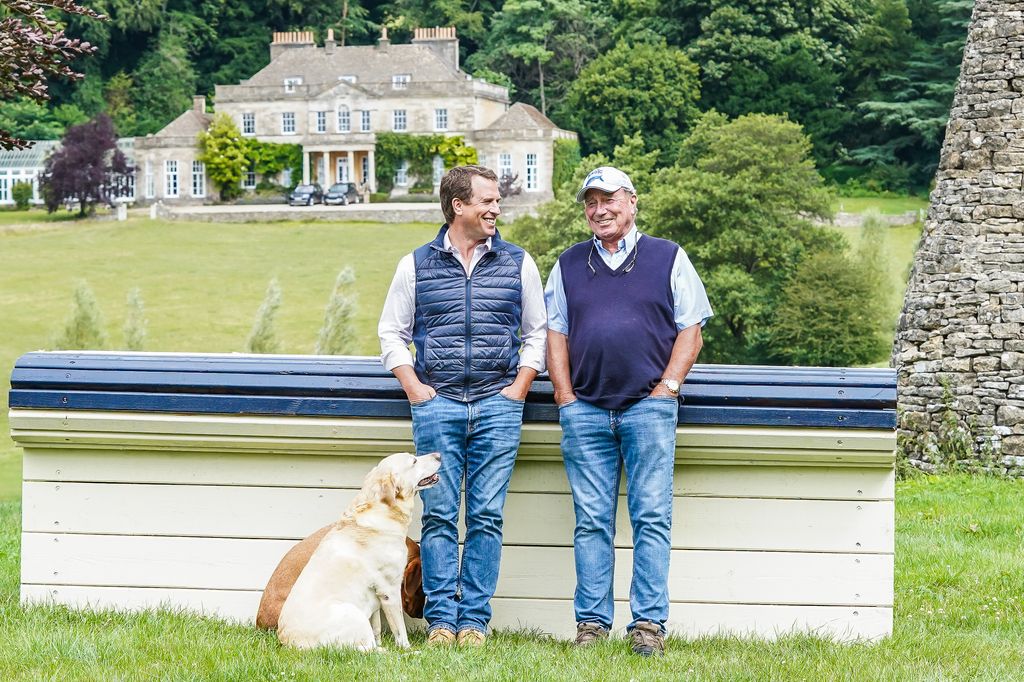 Peter Phillips and Captain Mark Phillips standing in front of Gatcombe Park house