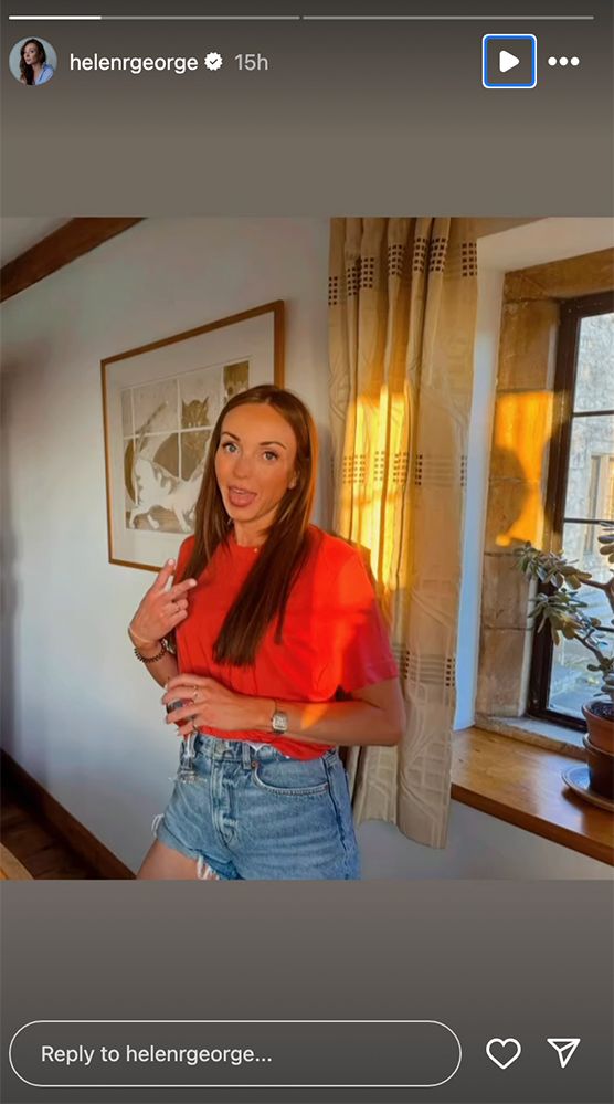 Helen George in a cottage wearing a red top and denim shorts 