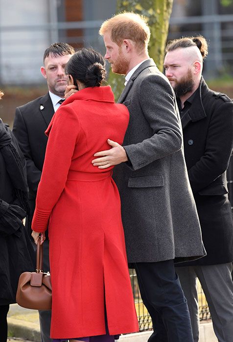 harry touches meghan back