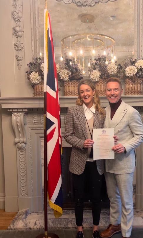 Storm Keating and Ronan Keating stood by a Union flag