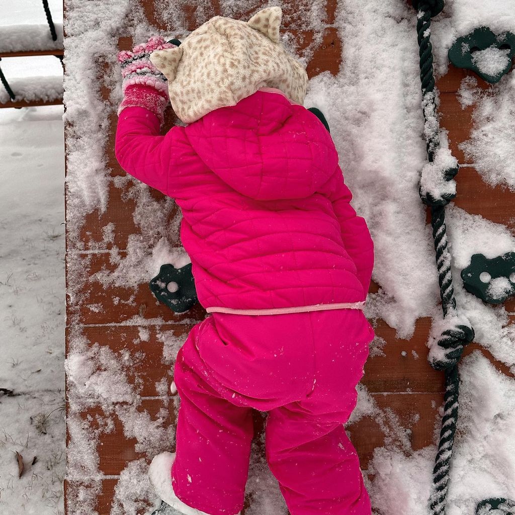 Gigi's daughter in pink snowsuit