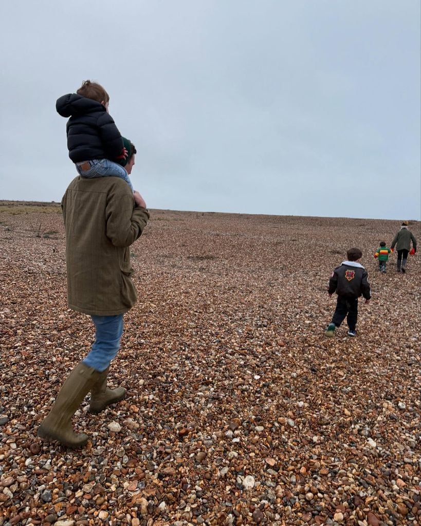 A photo of a man with a toddler on his shoulders 