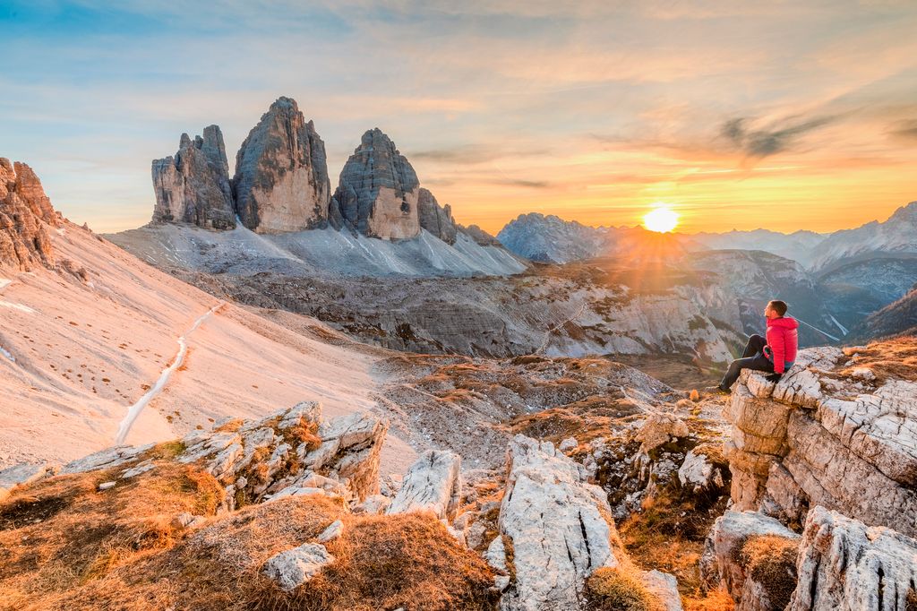 Man sitting in front of Three Peaks of Lavaredo, Dolomites, South Tyrol