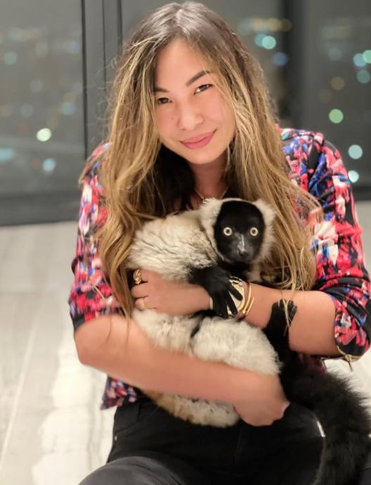 Lucy Guo holding a lemur