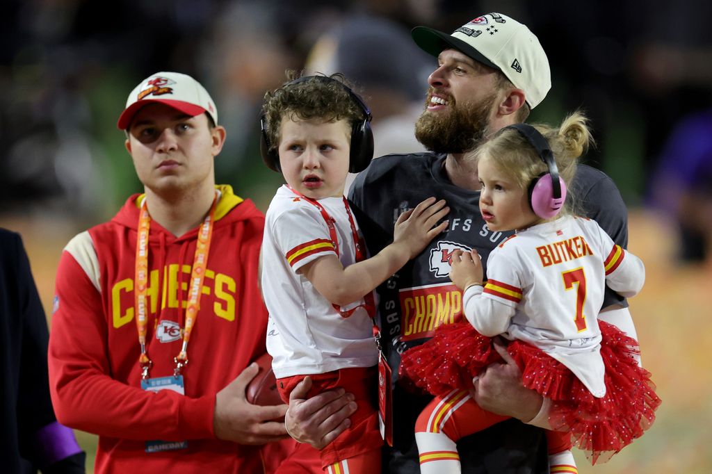 arrison Butker #7 of the Kansas City Chiefs celebrates with his children after kicking the go ahead field goal to beat the Philadelphia Eagles in Super Bowl LVII at State Farm Stadium on February 12, 2023 in Glendale, Arizona