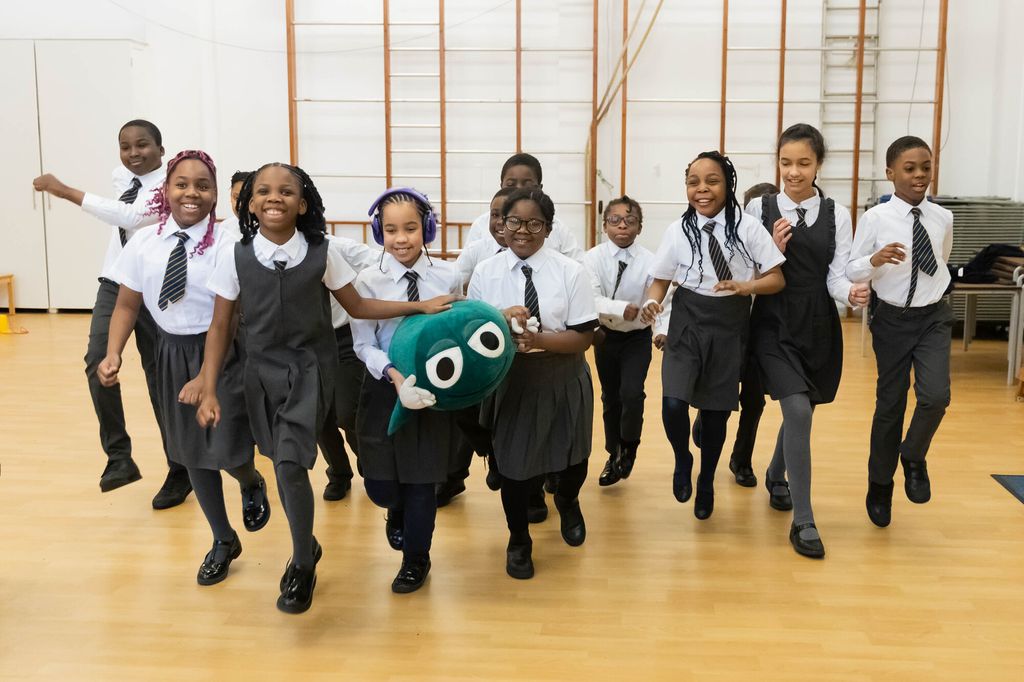 children in school hall running