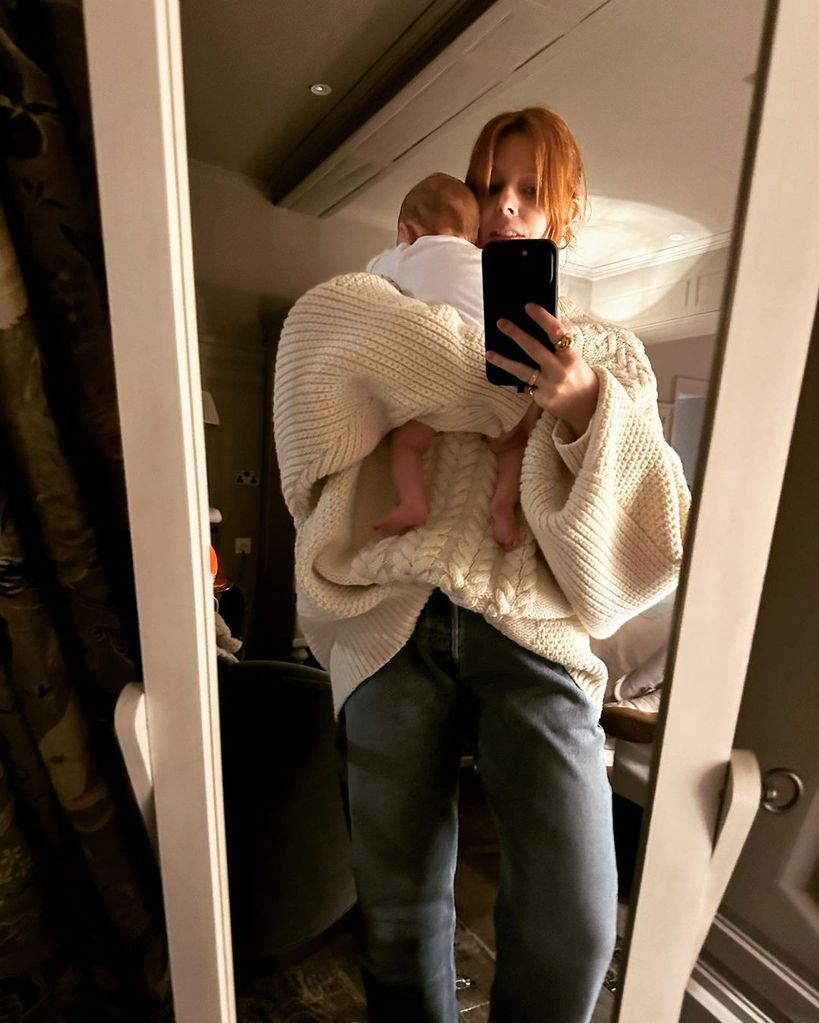 Stacey Dooley taking a mirror selfie with her baby daughter