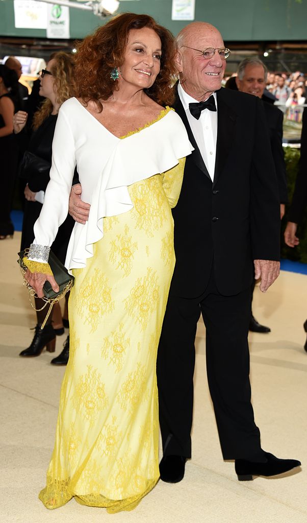 Diane von Furstenberg in a yellow and white dress with her husband Barry Diller 