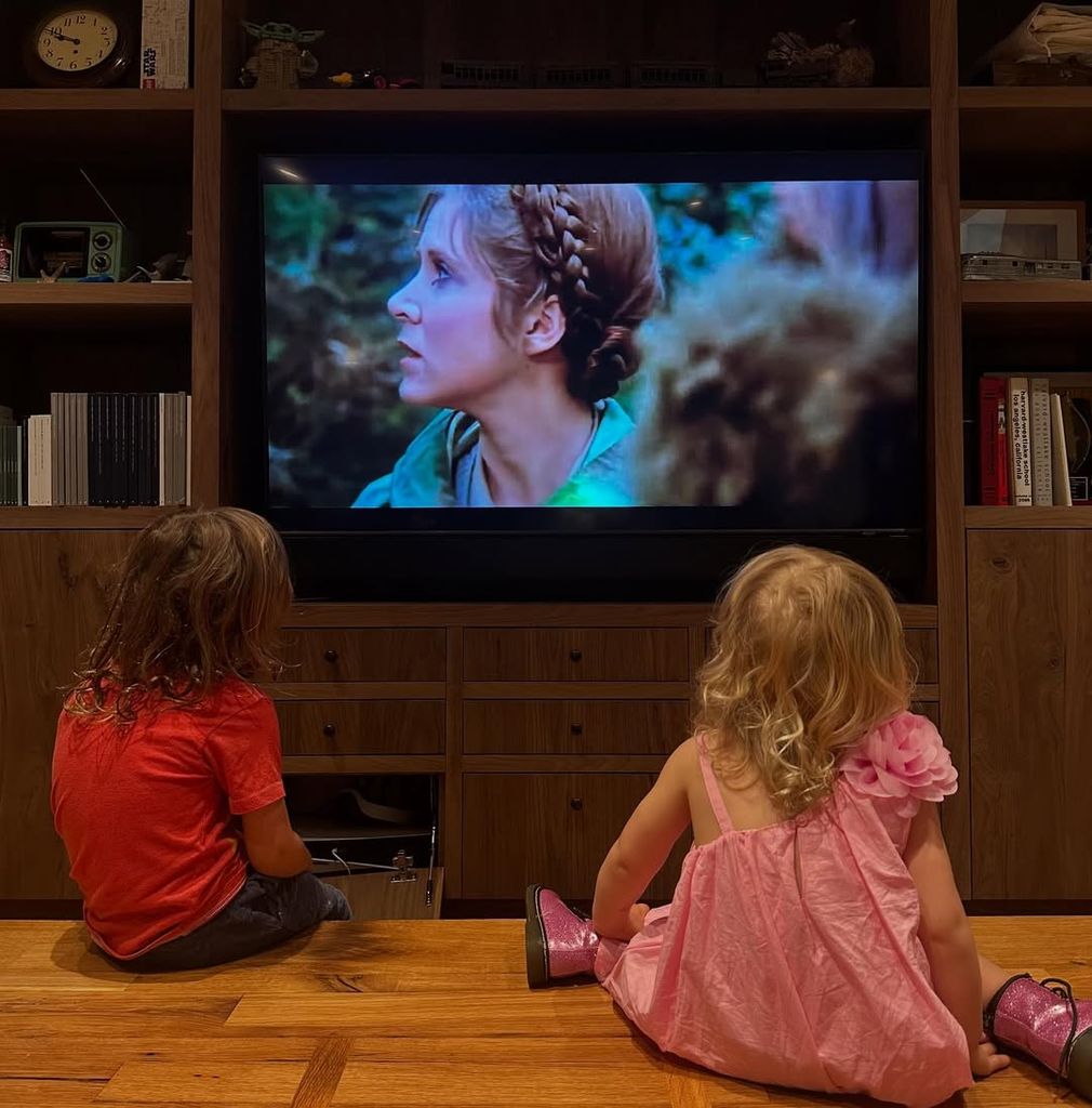 Billie Lourd's two children watch their grandmother Carrie Fisher as Princess Leia on a TV at home, shared on Instagram