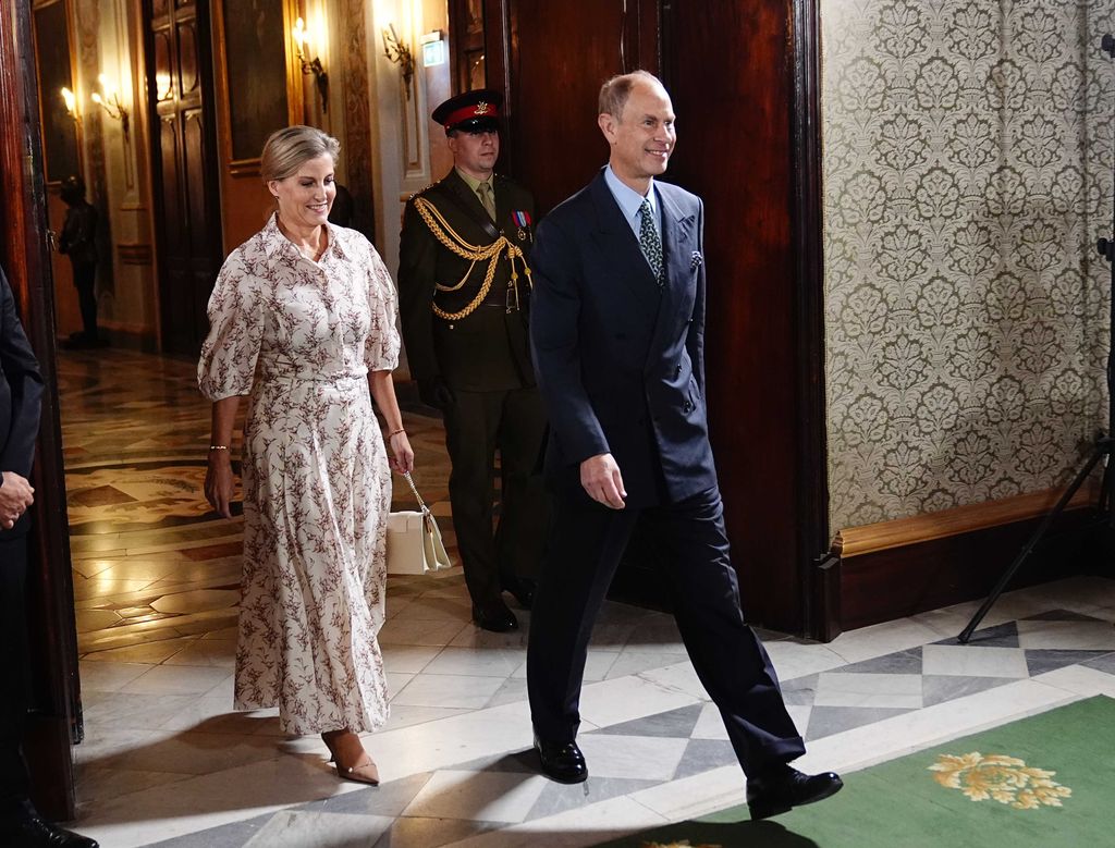 couple walking through ornate building